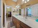 Large bathroom features a spacious vanity with double sinks and decorative mirrors at 1111 Carriage Park Dr, Valrico, FL 33594