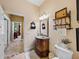 Powder room showcasing granite vanity with elegant decorations with view to an adjacent office at 1111 Carriage Park Dr, Valrico, FL 33594