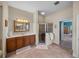 Bathroom featuring glass shower, tiled floors, vanity and view to the main bedroom suite at 1111 Carriage Park Dr, Valrico, FL 33594