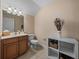 Cozy bathroom features a vanity, mirror, toilet and decorative items that add to the aesthetics at 1111 Carriage Park Dr, Valrico, FL 33594