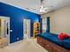 Bedroom with blue accent wall, carpet flooring, bed with storage, and ceiling fan at 1111 Carriage Park Dr, Valrico, FL 33594