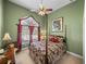 Elegant bedroom features a four-poster bed, decorative window treatments, and green walls at 1111 Carriage Park Dr, Valrico, FL 33594