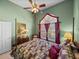 Cozy bedroom showcasing a four-poster bed, window with red curtains, and green walls at 1111 Carriage Park Dr, Valrico, FL 33594