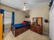 Bedroom with blue bedding, a ceiling fan, carpeted flooring and a dresser at 1111 Carriage Park Dr, Valrico, FL 33594