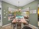 Dining area with view of pool and covered patio through large bay windows at 1111 Carriage Park Dr, Valrico, FL 33594