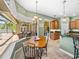Dining area with backyard, pool, and patio views through large bay window at 1111 Carriage Park Dr, Valrico, FL 33594