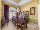 Dining room with large windows, chandelier, and a built-in display cabinet at 1111 Carriage Park Dr, Valrico, FL 33594