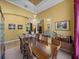 Bright dining room with decorative chandelier, art, and arched doorways at 1111 Carriage Park Dr, Valrico, FL 33594