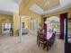 Open-concept dining room and foyer with chandelier and elegant tile flooring at 1111 Carriage Park Dr, Valrico, FL 33594