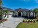 A beautiful home featuring well-kept landscaping, a spacious driveway, and an inviting front entrance at 1111 Carriage Park Dr, Valrico, FL 33594