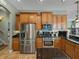 Well-equipped kitchen featuring stainless steel appliances and black granite countertops at 1111 Carriage Park Dr, Valrico, FL 33594