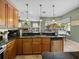Kitchen with wooden cabinets, black granite countertops, and view of the backyard pool at 1111 Carriage Park Dr, Valrico, FL 33594