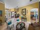 Well-decorated living room with arched doorways leading to the foyer, kitchen, and other rooms at 1111 Carriage Park Dr, Valrico, FL 33594