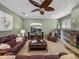 Relaxing living room with a ceiling fan and a view of the fireplace at 1111 Carriage Park Dr, Valrico, FL 33594