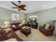 Inviting living room with comfortable leather seating and a ceiling fan for a relaxing atmosphere at 1111 Carriage Park Dr, Valrico, FL 33594