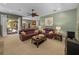 Bright living room featuring plush leather furniture, neutral carpet, and direct access to the outdoor patio at 1111 Carriage Park Dr, Valrico, FL 33594
