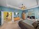 Bright and airy main bedroom with a ceiling fan and convenient access to other areas of the home at 1111 Carriage Park Dr, Valrico, FL 33594