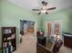 Bright office space featuring a ceiling fan, desk and access to the lanai and adjacent to the main bedroom at 1111 Carriage Park Dr, Valrico, FL 33594