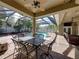 Inviting patio with dining table and chairs offering a perfect spot for outdoor meals by the pool at 1111 Carriage Park Dr, Valrico, FL 33594