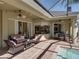 Beautiful patio with comfortable wicker furniture & dining area, perfect for entertaining by the pool at 1111 Carriage Park Dr, Valrico, FL 33594