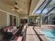 Beautiful patio with comfortable wicker furniture & dining area, perfect for relaxing by the pool at 1111 Carriage Park Dr, Valrico, FL 33594