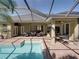 Enjoy outdoor entertaining on this covered brick patio with views of the screened pool at 1111 Carriage Park Dr, Valrico, FL 33594