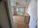 Bedroom featuring hardwood floors, built in drawers and shelving, with a ceiling fan at 1530 Davenport Dr, New Port Richey, FL 34655