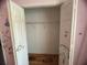Empty closet with hardwood floors, a wire shelf, and decorations on the inside of the door at 1530 Davenport Dr, New Port Richey, FL 34655