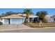 Single-Gathering home featuring a two-car garage and mature landscaping at 1530 Davenport Dr, New Port Richey, FL 34655