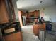 Kitchen featuring granite counters, wooden cabinets, and stainless steel appliances at 1530 Davenport Dr, New Port Richey, FL 34655