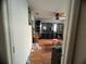 Living room with hardwood floors, a ceiling fan, a mirror, and built-in shelving at 1530 Davenport Dr, New Port Richey, FL 34655