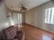 Living room featuring wood floors, ceiling fan and sliding doors at 1530 Davenport Dr, New Port Richey, FL 34655