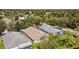 An aerial view showcases houses with screened-in patios, nestled among mature trees in a well-kept neighborhood at 15555 Martinmeadow Dr, Lithia, FL 33547