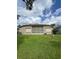 Cozy home features a spacious backyard with a screened-in patio for outdoor enjoyment at 15555 Martinmeadow Dr, Lithia, FL 33547