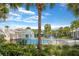 Community pool featuring a rock waterfall, lush landscaping, and clear blue water under a sunny sky at 15555 Martinmeadow Dr, Lithia, FL 33547