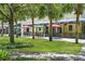 Charming outdoor dining area with colorful umbrellas, tables, and a view of the community park at 15555 Martinmeadow Dr, Lithia, FL 33547