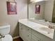 Bright bathroom with marble countertop sink and decorative art at 1655 S Highland Ave # J193, Clearwater, FL 33756