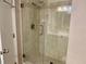 Bathroom shower with glass door and tiled walls at 1655 S Highland Ave # J193, Clearwater, FL 33756