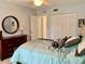 Cozy bedroom with a ceiling fan, double door closet, and soft bedding at 1655 S Highland Ave # J193, Clearwater, FL 33756