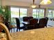 Open dining room with black cushioned chairs, water views, and modern lighting at 1655 S Highland Ave # J193, Clearwater, FL 33756