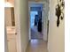 Hallway view to bedroom and full length mirror, with bathroom adjacent at 1655 S Highland Ave # J193, Clearwater, FL 33756