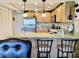 Charming kitchen featuring granite counters, stainless steel appliances, and classic pendant lighting at 1655 S Highland Ave # J193, Clearwater, FL 33756