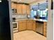 Lovely kitchen features light wood cabinetry, granite counters, and stainless steel appliances at 1655 S Highland Ave # J193, Clearwater, FL 33756
