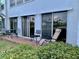 Tranquil patio with brick flooring, various chairs, and a scenic view of the pond at 1655 S Highland Ave # J193, Clearwater, FL 33756