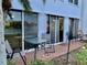 Relaxing outdoor patio with brick flooring, sliding glass doors, and picturesque views of the lake at 1655 S Highland Ave # J193, Clearwater, FL 33756