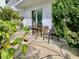 Relaxing patio area with a round table and chairs, perfect for outdoor dining and enjoying the scenery at 1655 S Highland Ave # J193, Clearwater, FL 33756
