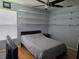 Comfortable bedroom with open wall shelves, hardwood floors, and a ceiling fan at 1735 Tall Pine Cir, Safety Harbor, FL 34695