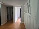 Bright hallway with hardwood floors leading to rooms with neutral walls and ample storage space at 1735 Tall Pine Cir, Safety Harbor, FL 34695