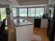 Bright kitchen features an island with cooktop, a large picture window, and stainless steel appliances at 1735 Tall Pine Cir, Safety Harbor, FL 34695