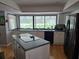 Bright kitchen features an island with cooktop, a large picture window, and stainless steel appliances at 1735 Tall Pine Cir, Safety Harbor, FL 34695